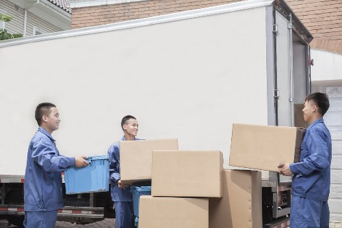 Professional movers handling furniture in a Belgravia townhouse