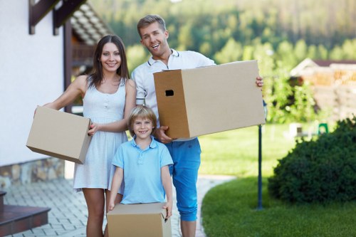 Trained movers handling boxes during a Belgravia relocation