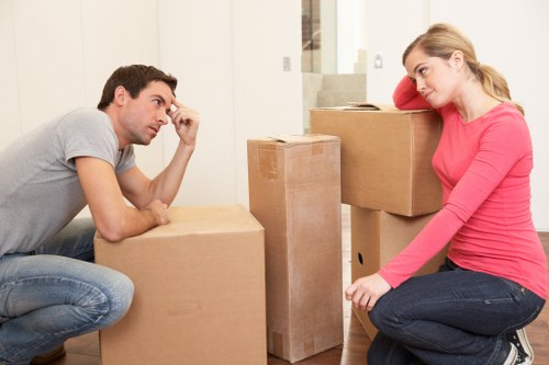 Professional moving team handling furniture with van in Belgravia